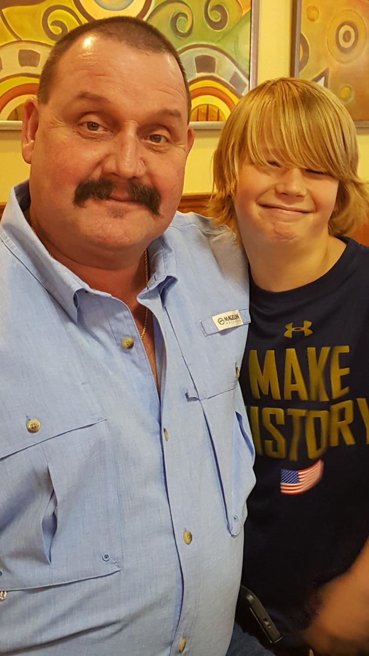 Two people smile joyfully together at a relaxed social event.