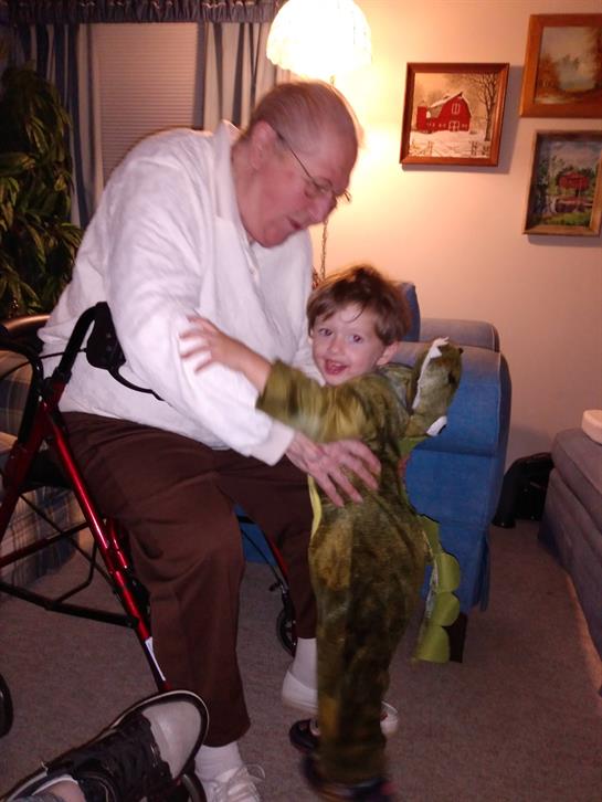 An old man and a young boy in a dinosaur garment