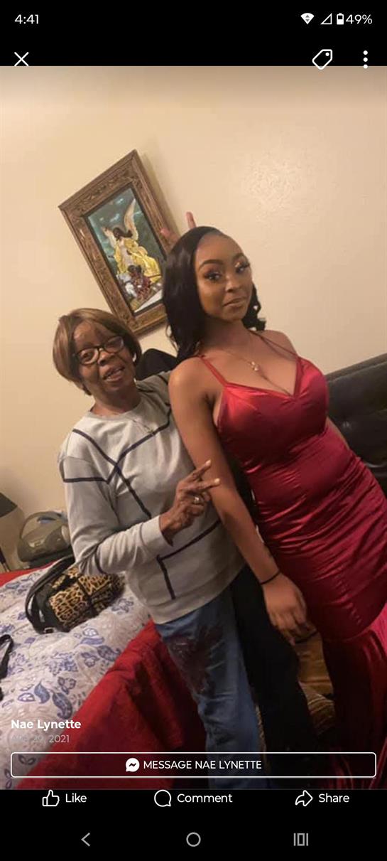 A woman standing next to another woman