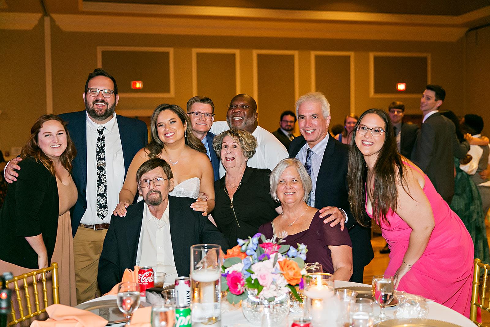 Friends and family gather, smiling and celebrating together during a festive occasion.