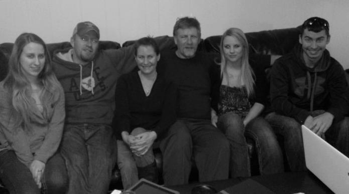 Group of friends relaxes together on a couch, enjoying each other's company and sharing stories.