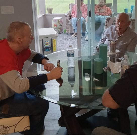 A group of men sitting around a glass table