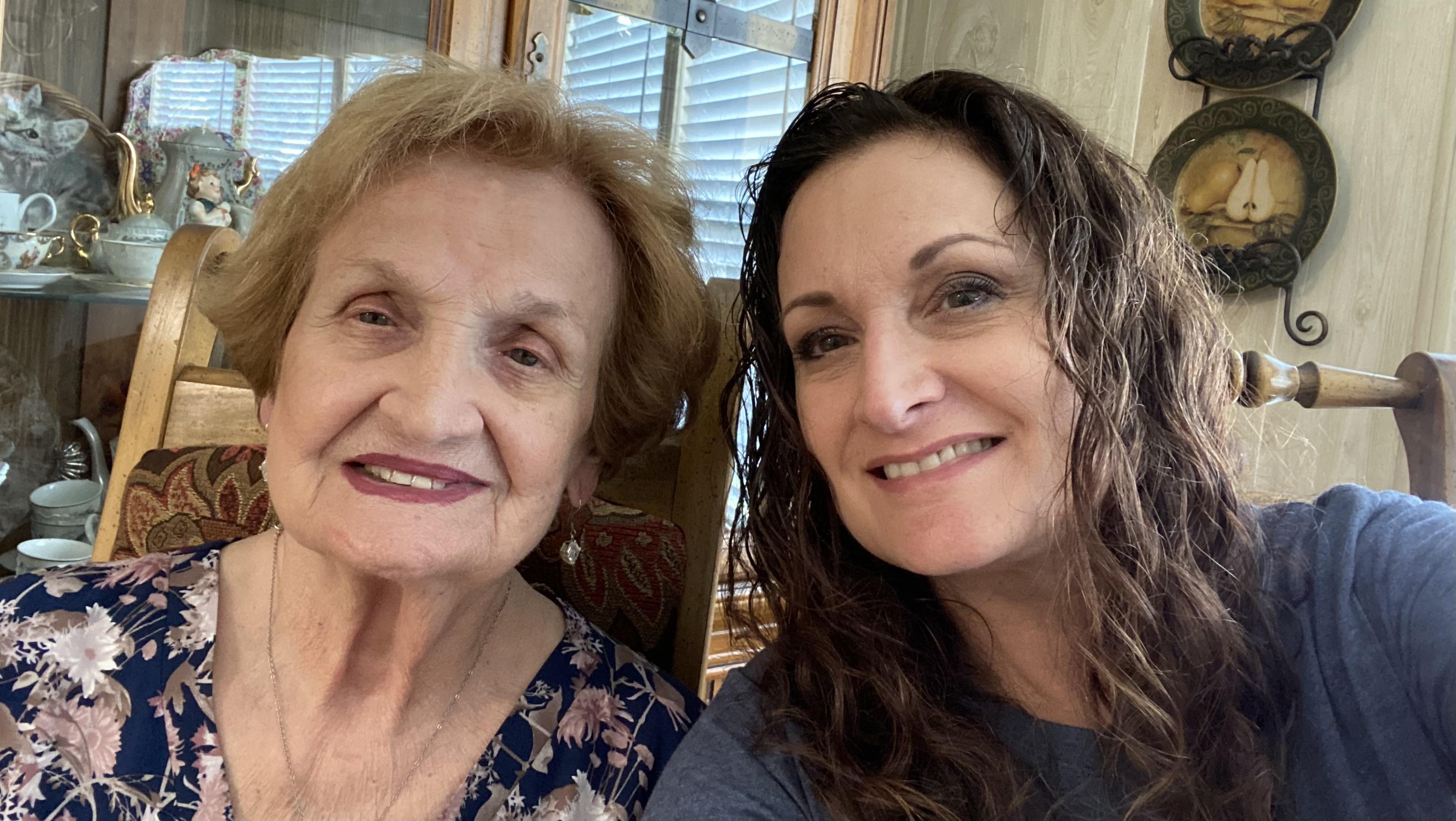 Two women share joyful moments together, smiling and enjoying each other's company during a visit.