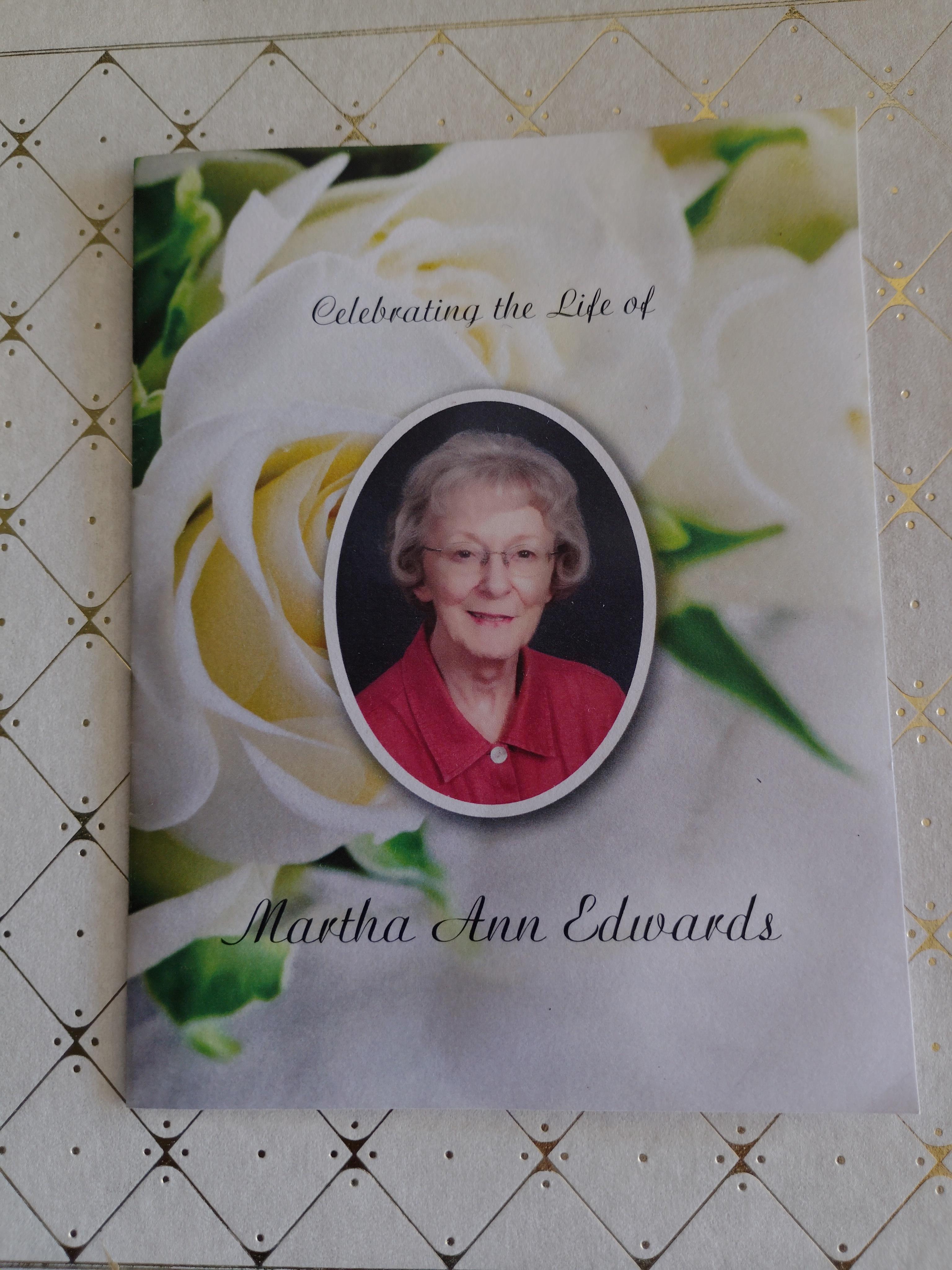 A tribute program honors Martha Ann Edwards, featuring her portrait surrounded by beautiful flowers.