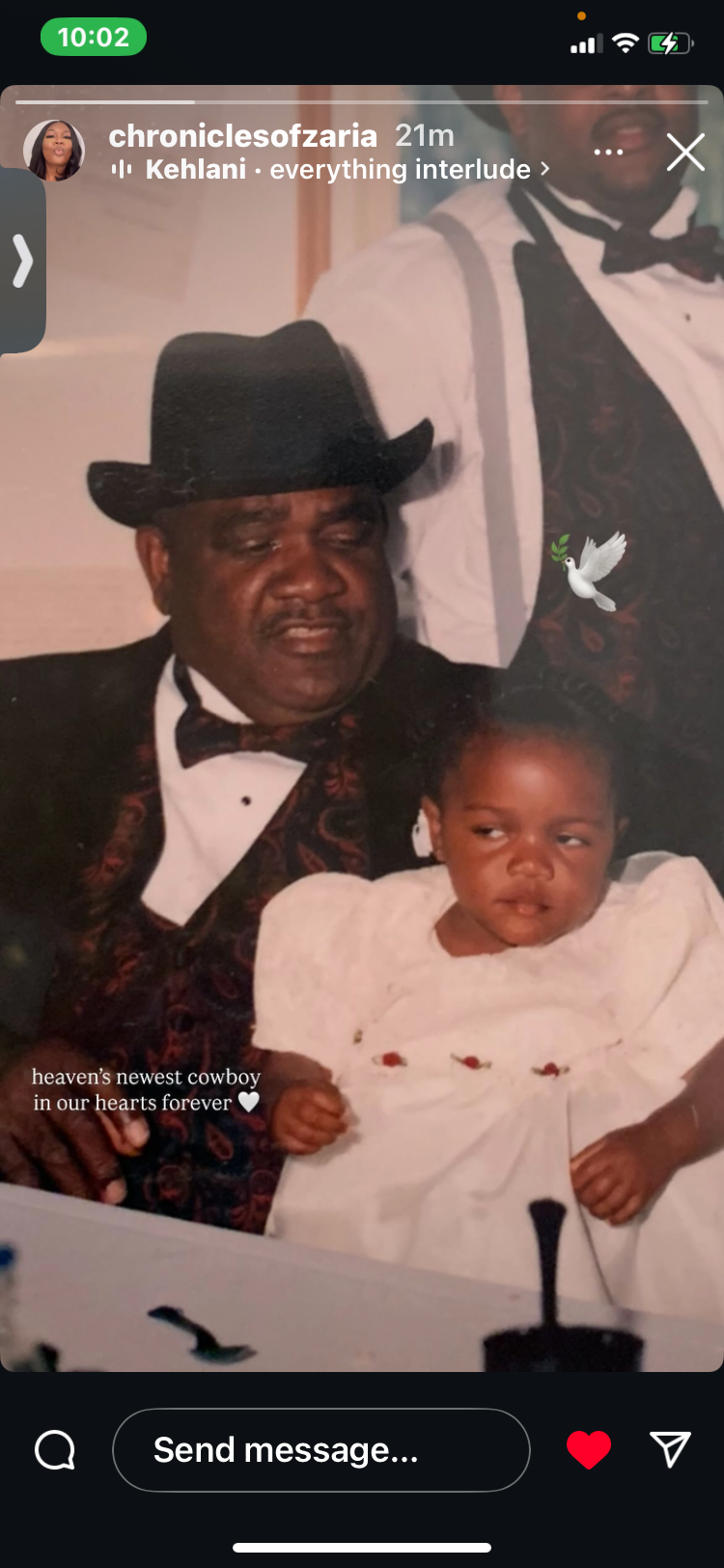 A grandfather joyfully sits with his granddaughter during a family event, showcasing their bond.