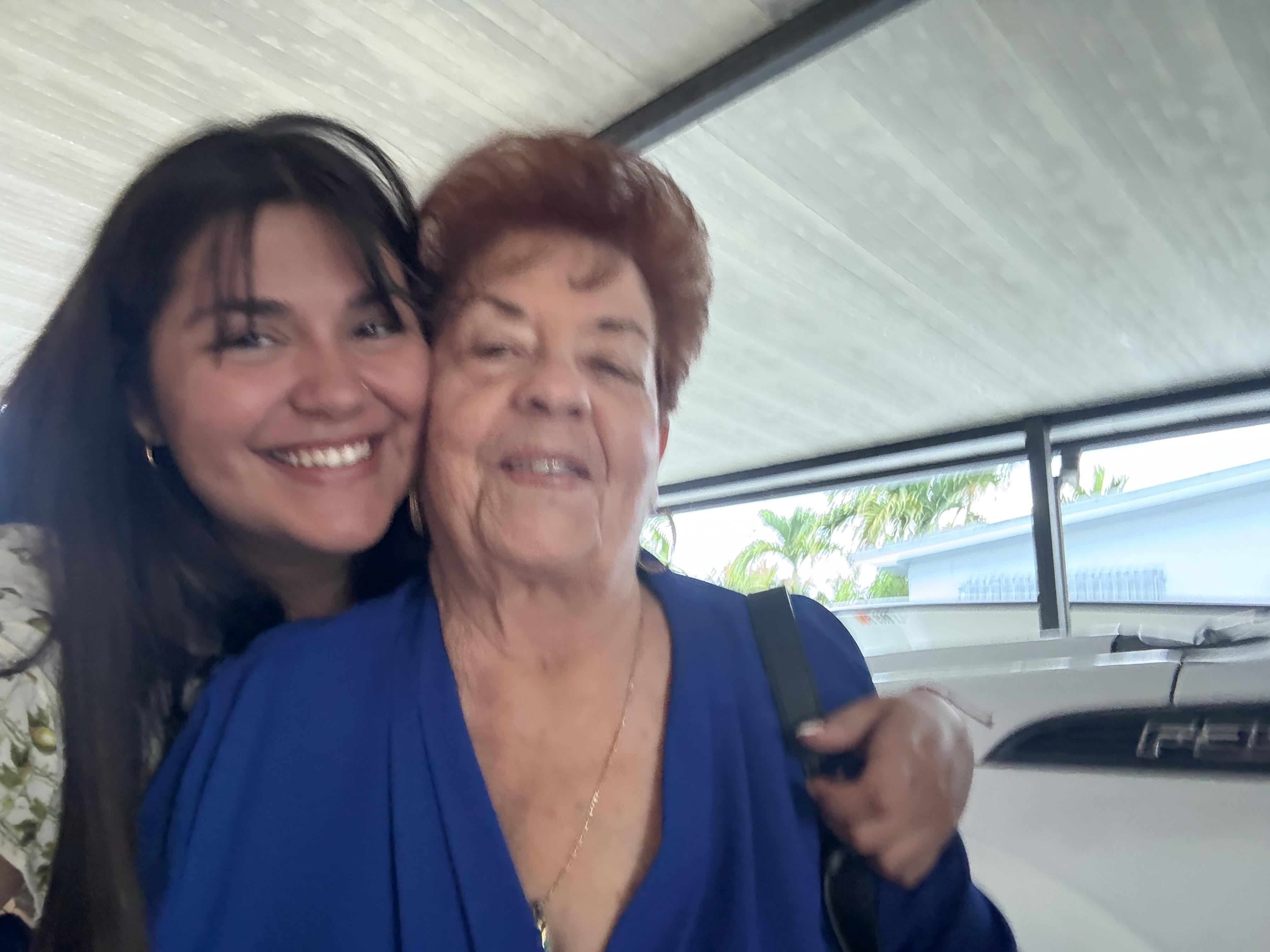 Two women share a joyful embrace at a family gathering, radiating warmth and happiness.