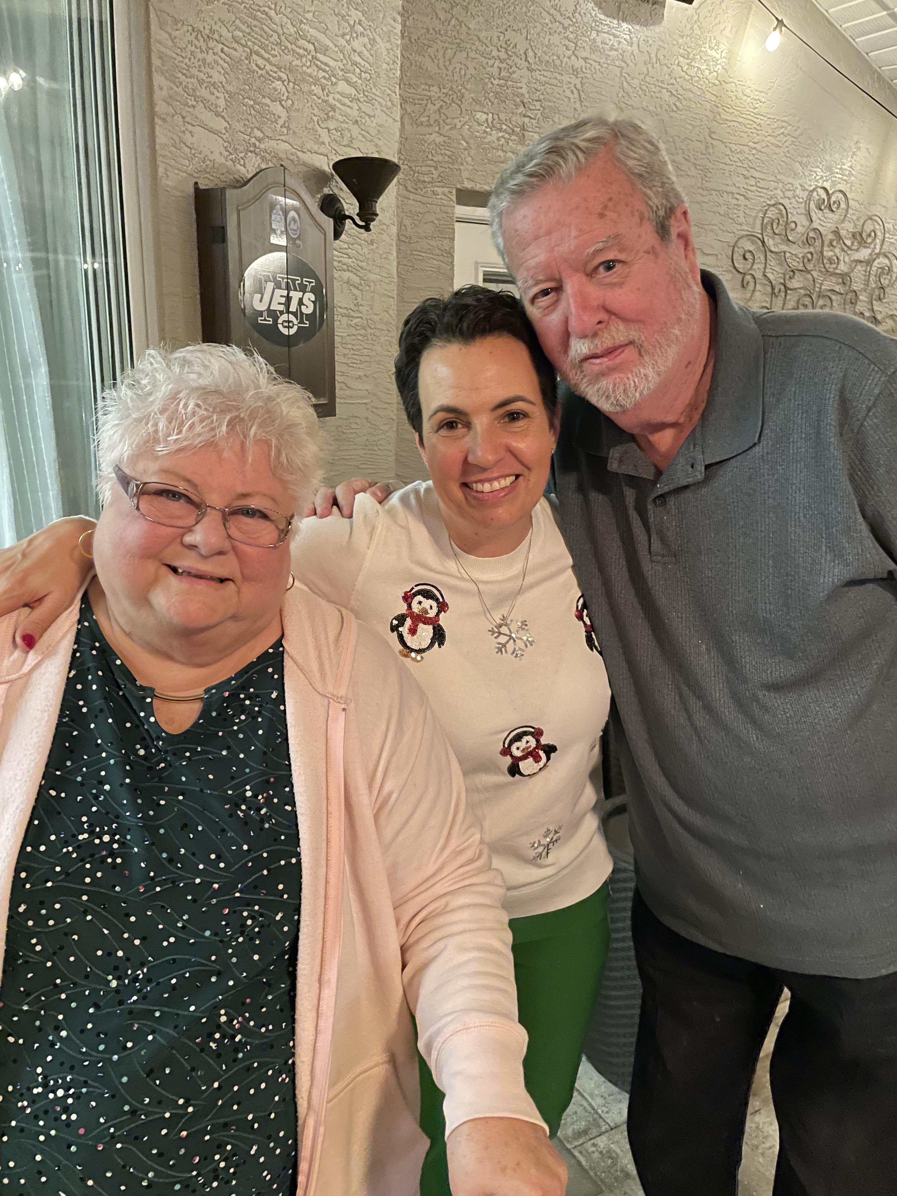 Friends enjoy warm company and smiles while celebrating the winter holiday with festive attire.