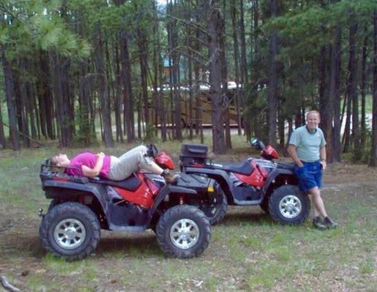 A man and woman lying on a four wheeler
