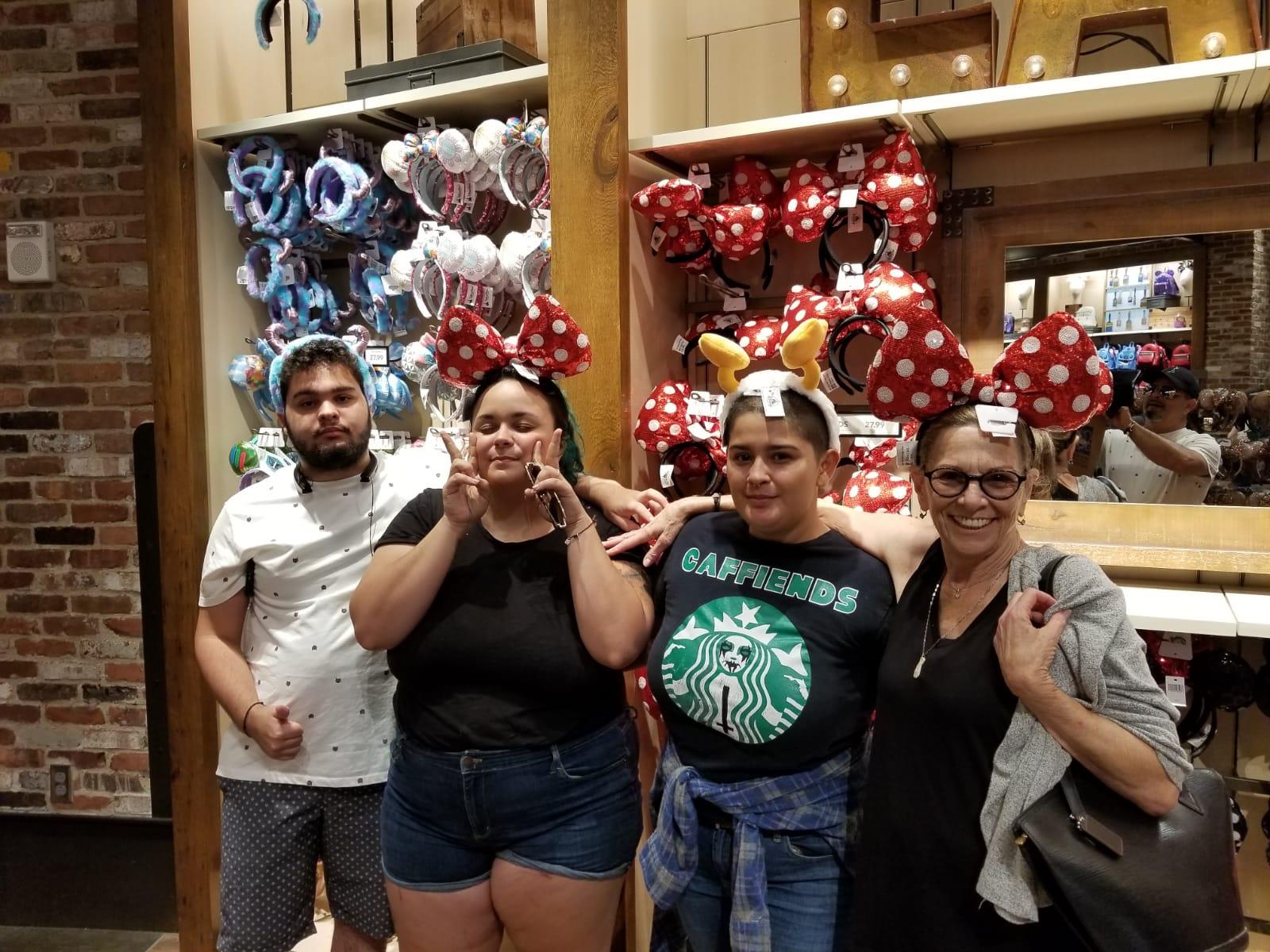 Friends celebrate by trying on playful hats inside a vibrant shop, sharing laughter and joy.