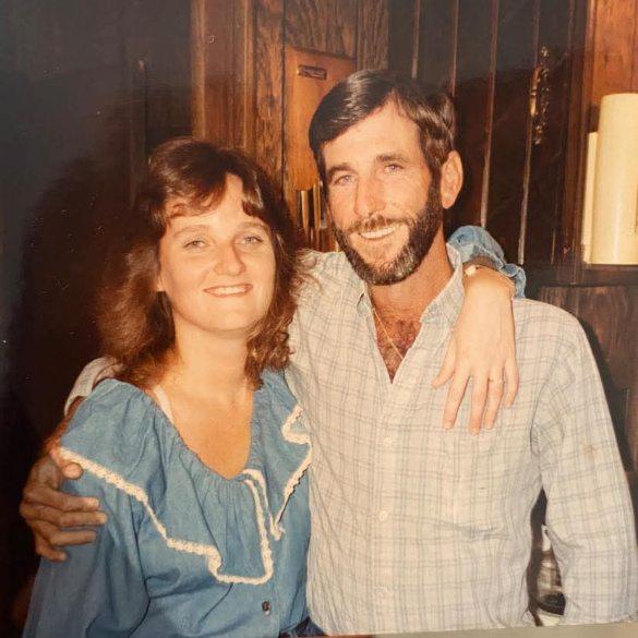 A man and woman posing for a picture