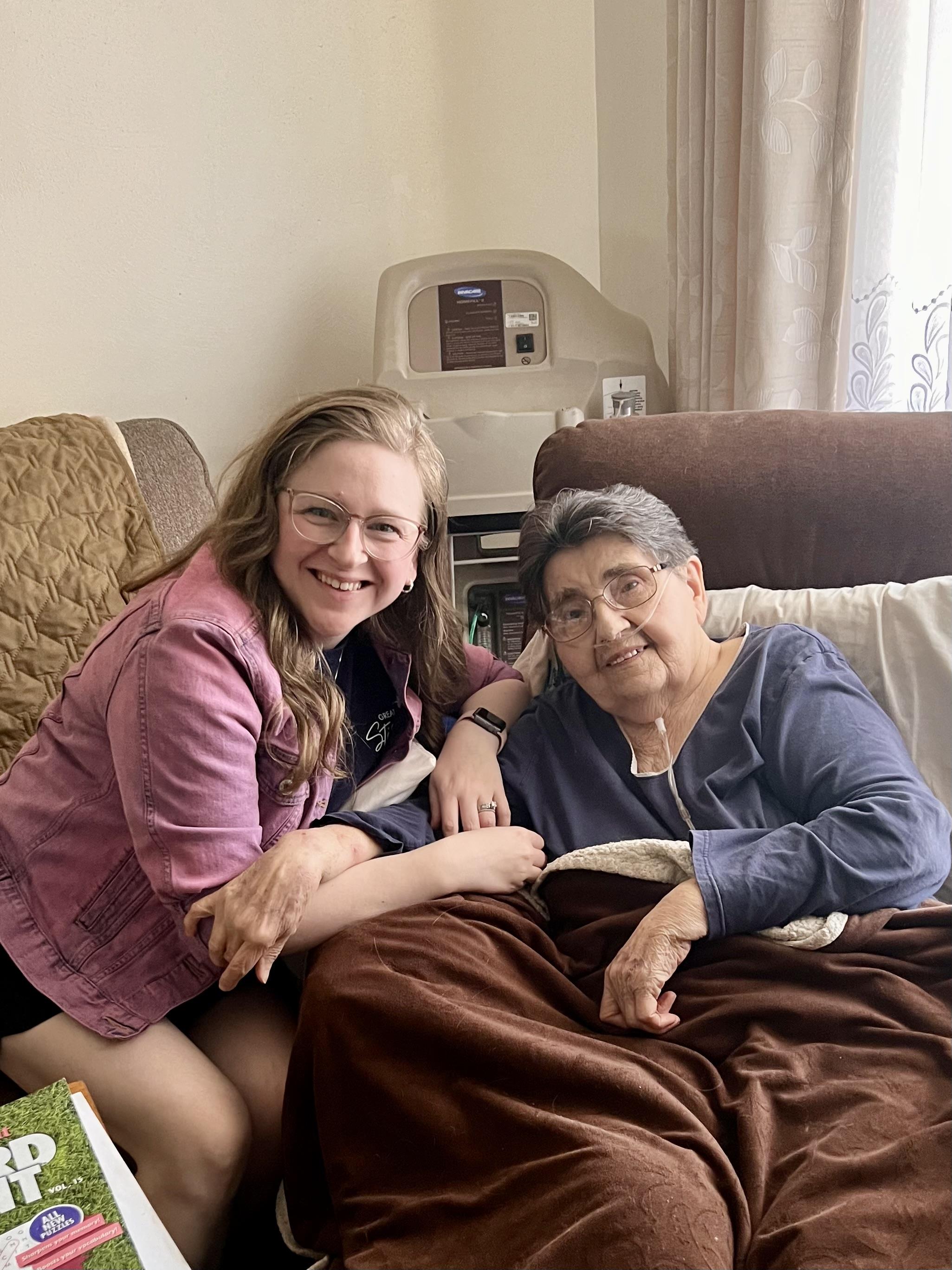 Two women enjoy quality time together in a warm living room filled with laughter and love.