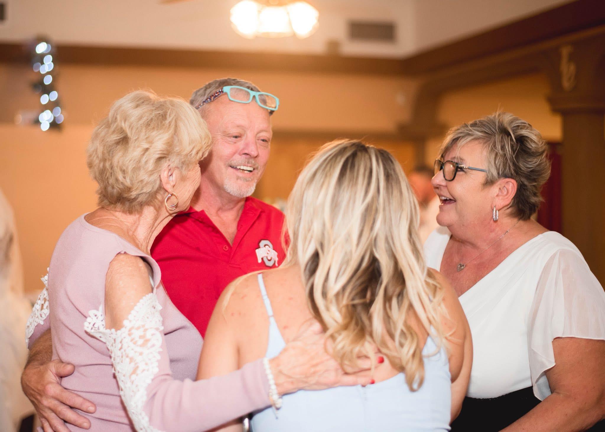 Group of friends engaging in lively conversation and laughter during a social gathering.