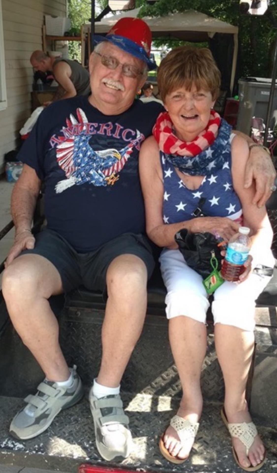 Couple in patriotic outfits enjoys the holiday spirit and each other's company.