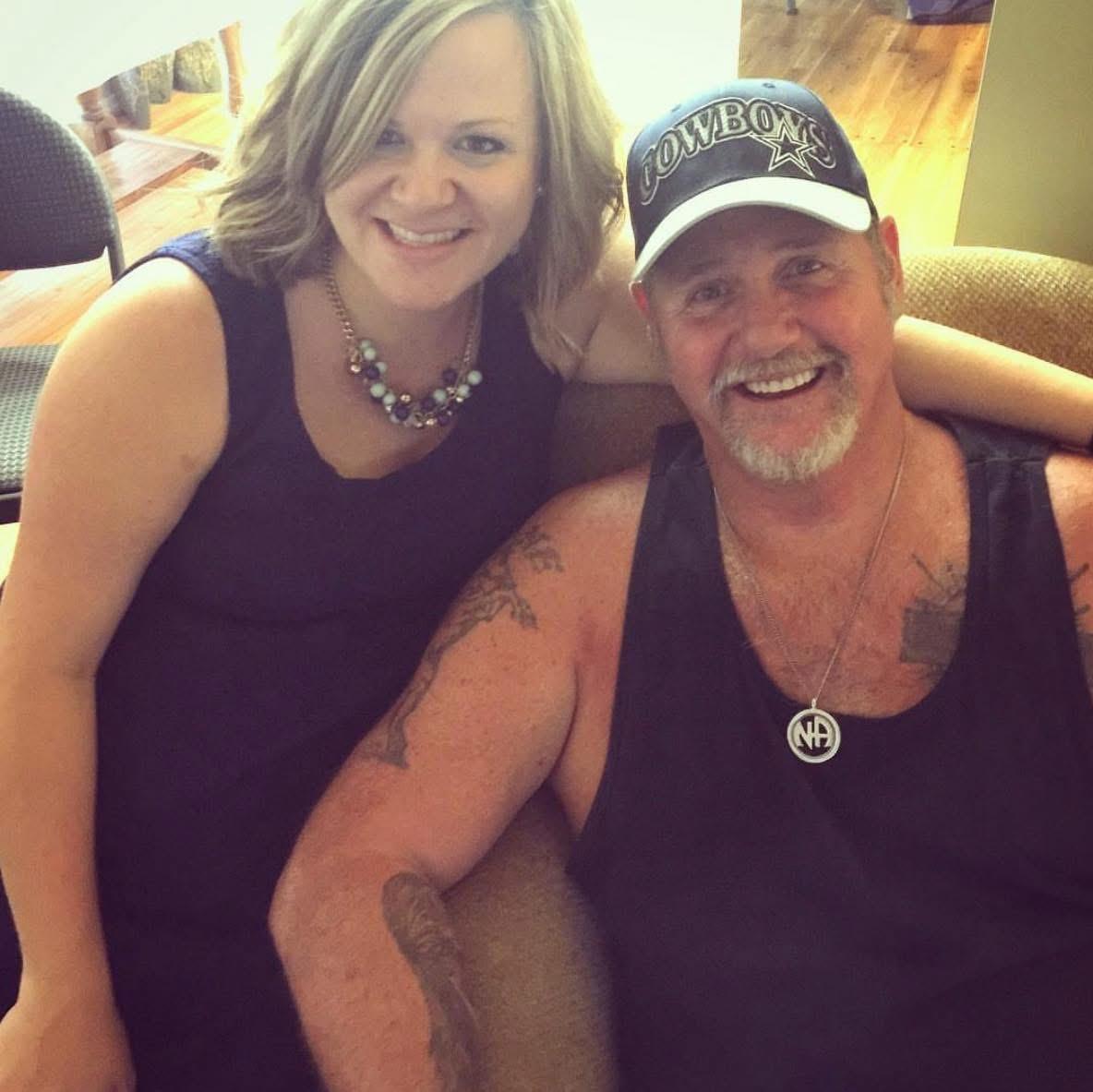 A woman and a man take a break, smiling happily, while enjoying a relaxed moment in their home.