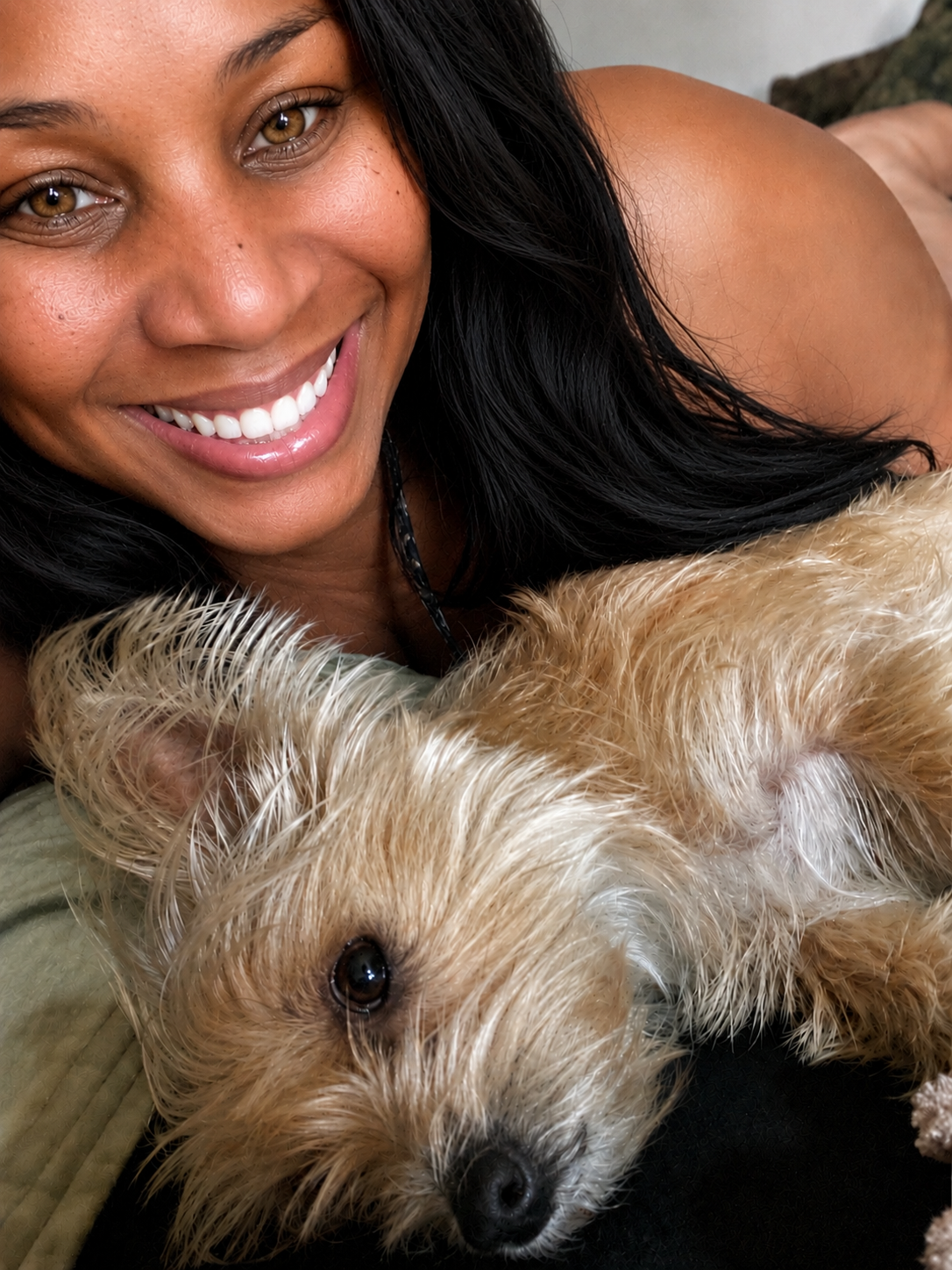 A woman smiling with a dog