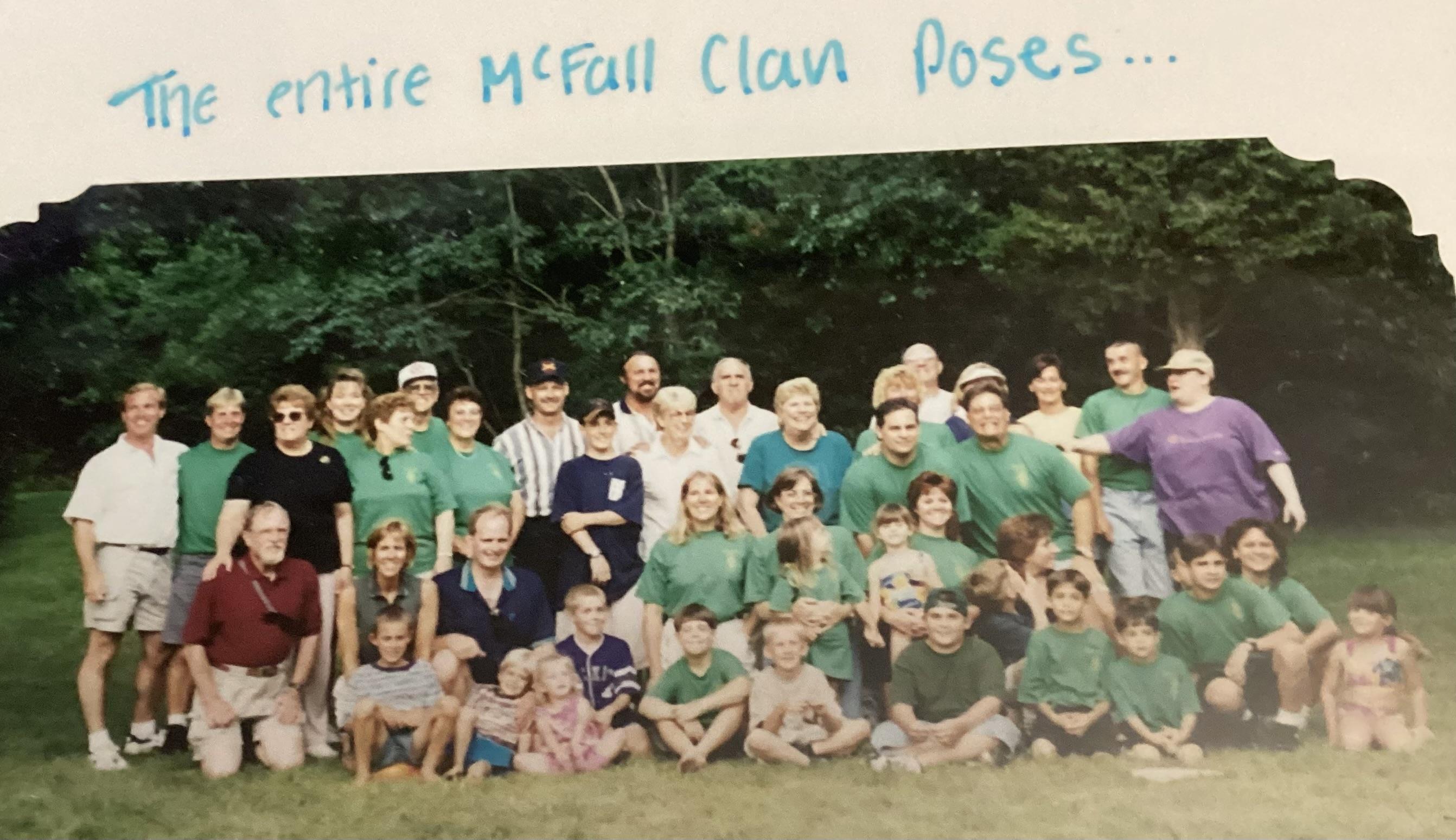 Family members celebrate together, wearing matching shirts and enjoying a beautiful day outdoors.