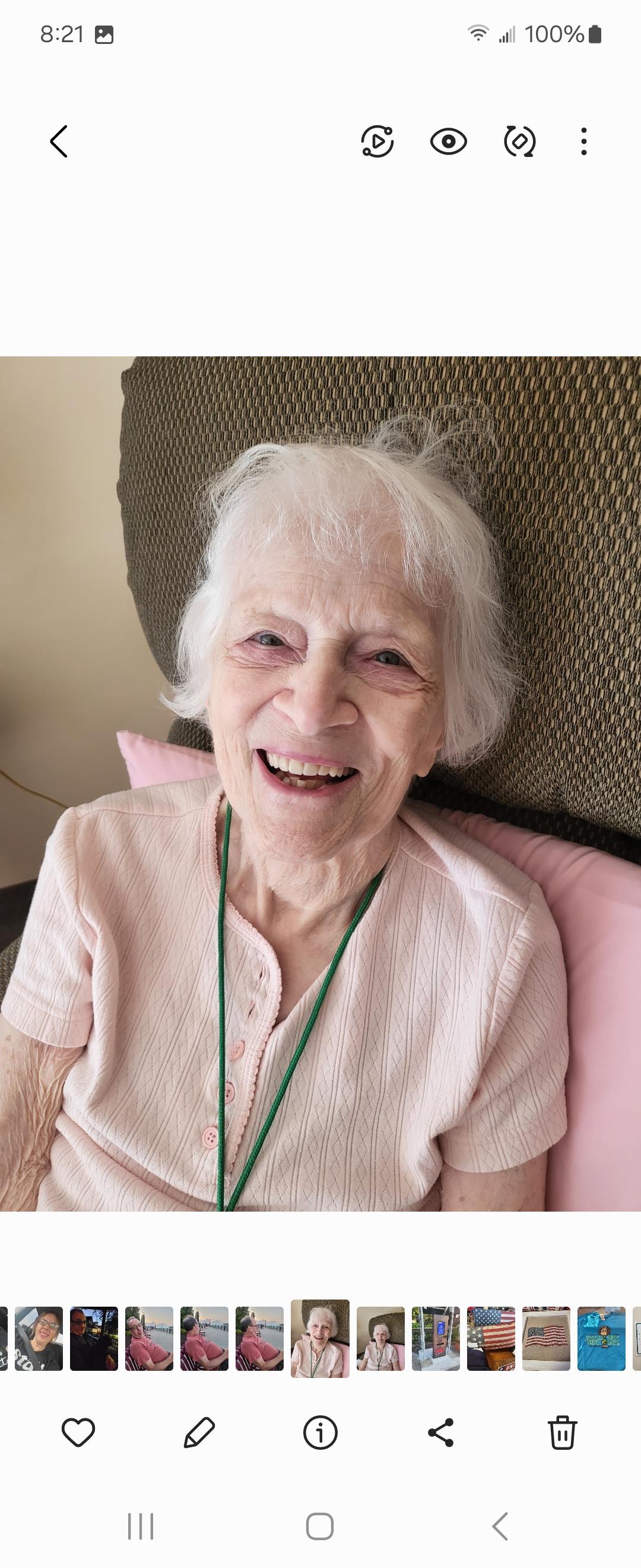 A cheerful elderly woman enjoying her time in a comfortable chair, radiating joy and warmth.