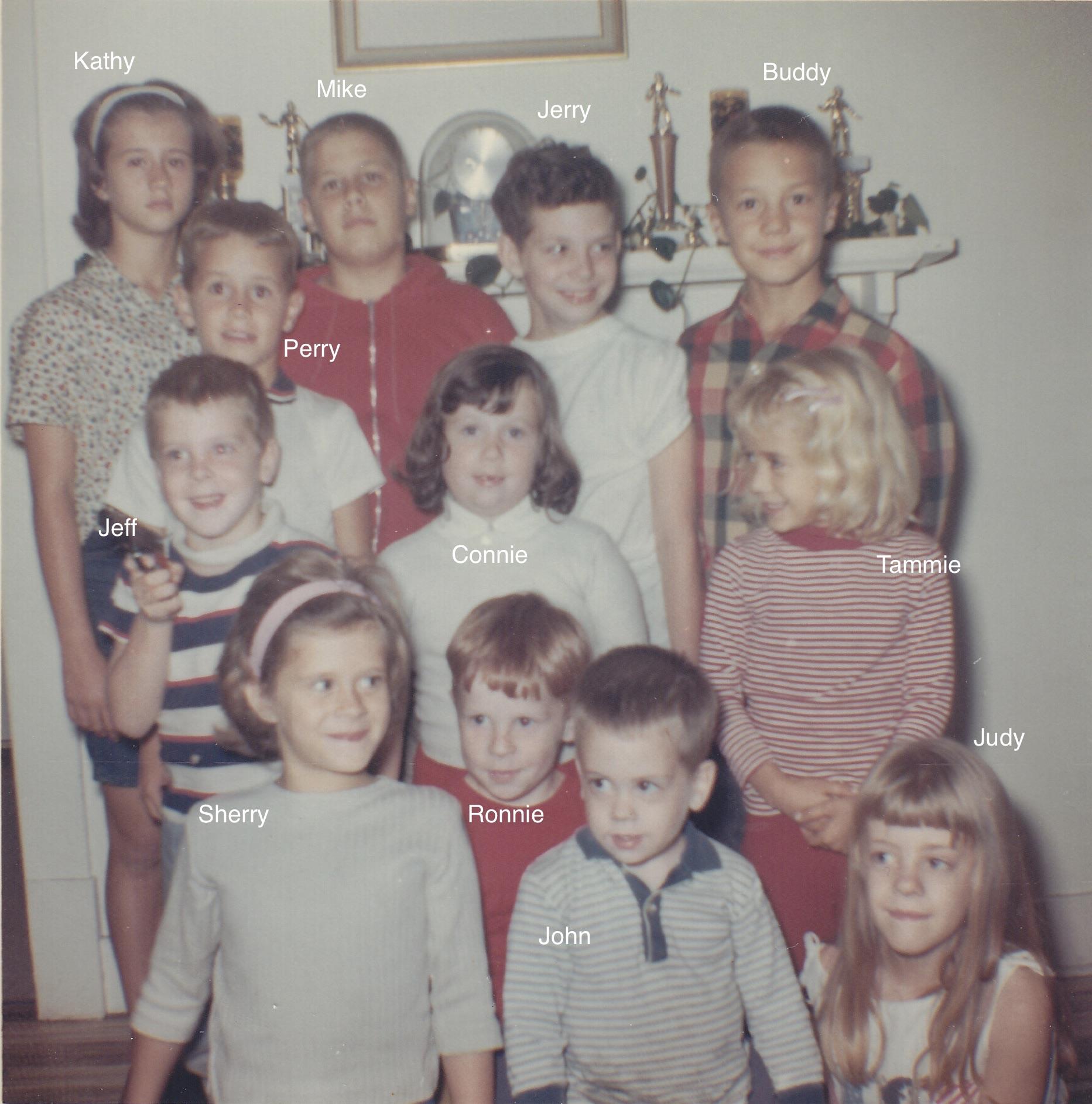 Twelve children gather in a cozy living room, smiling and enjoying their time together in the 1960s.