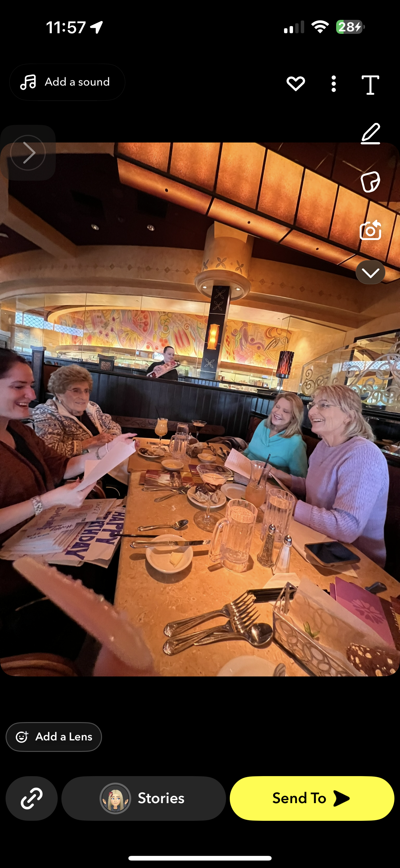 Four women enjoy a lively lunch, sharing laughter and conversation over delicious food and drinks.