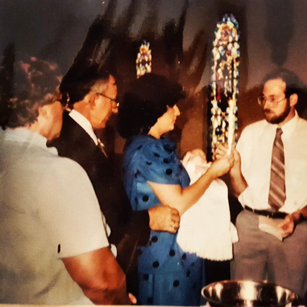 Family gathers to celebrate with gifts and joy in a festive atmosphere.