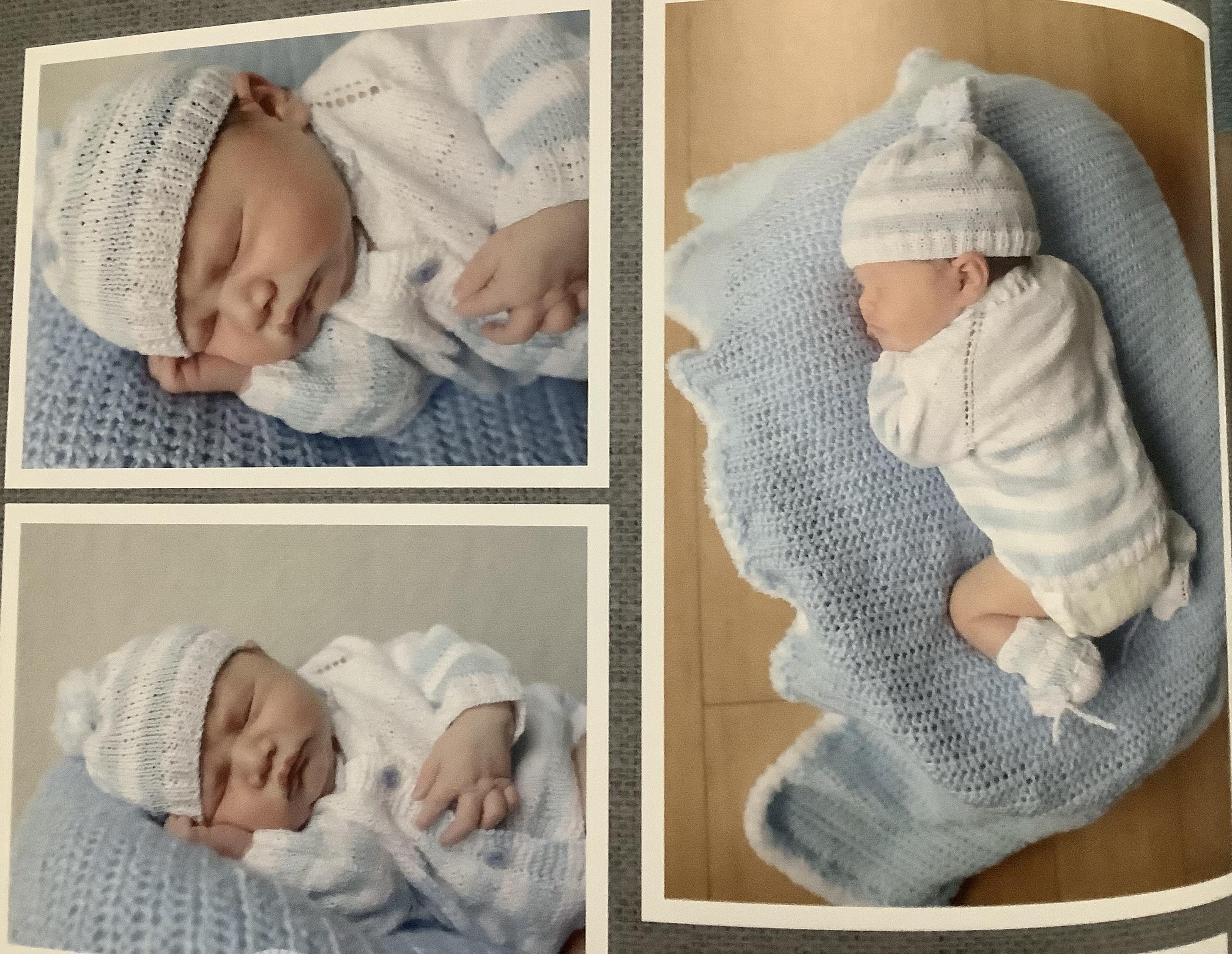 A baby in a blue blanket and matching hat sleeps peacefully in a calm indoor setting.