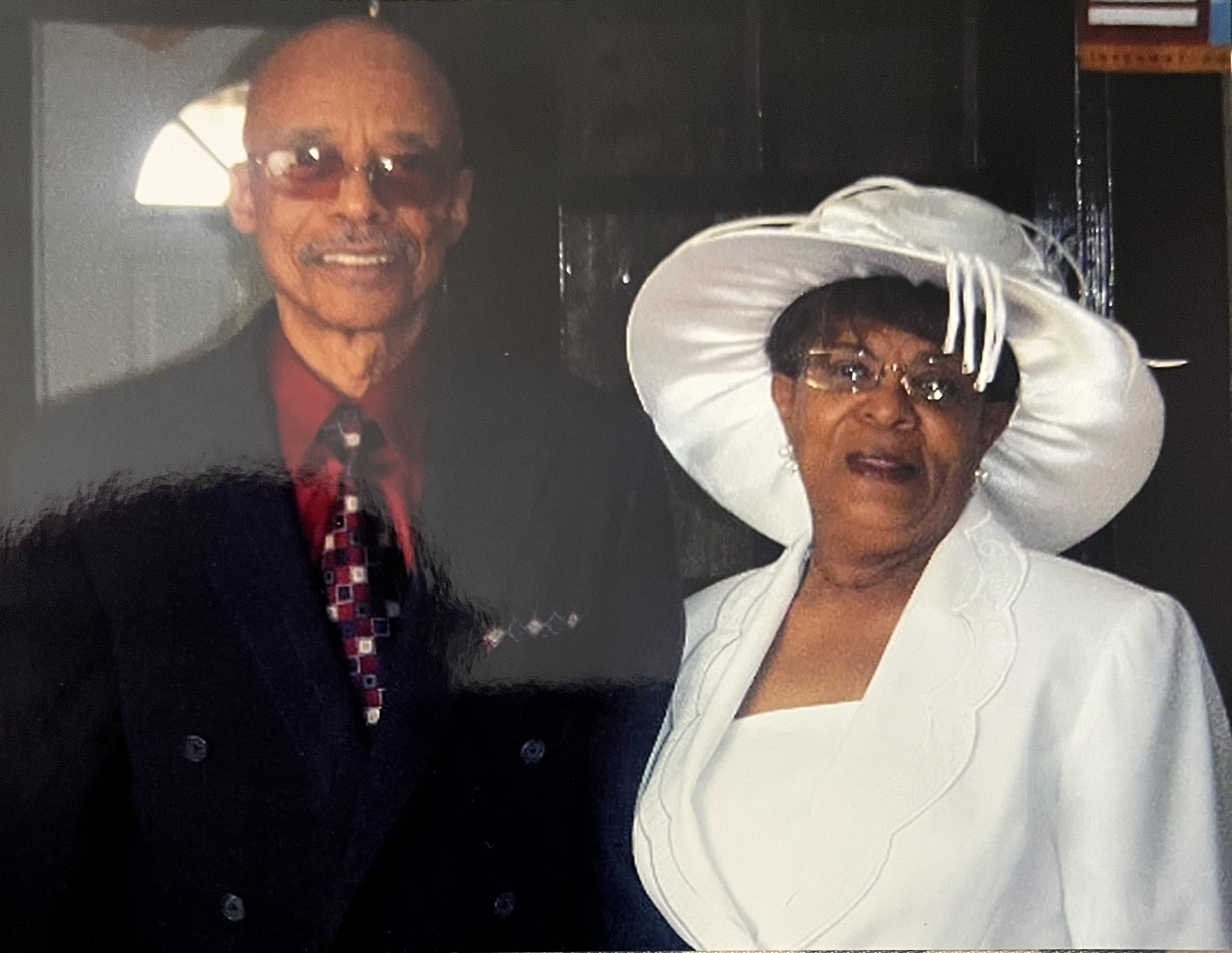 A stylish couple at a formal event, flaunting their elegant outfits and accessories.