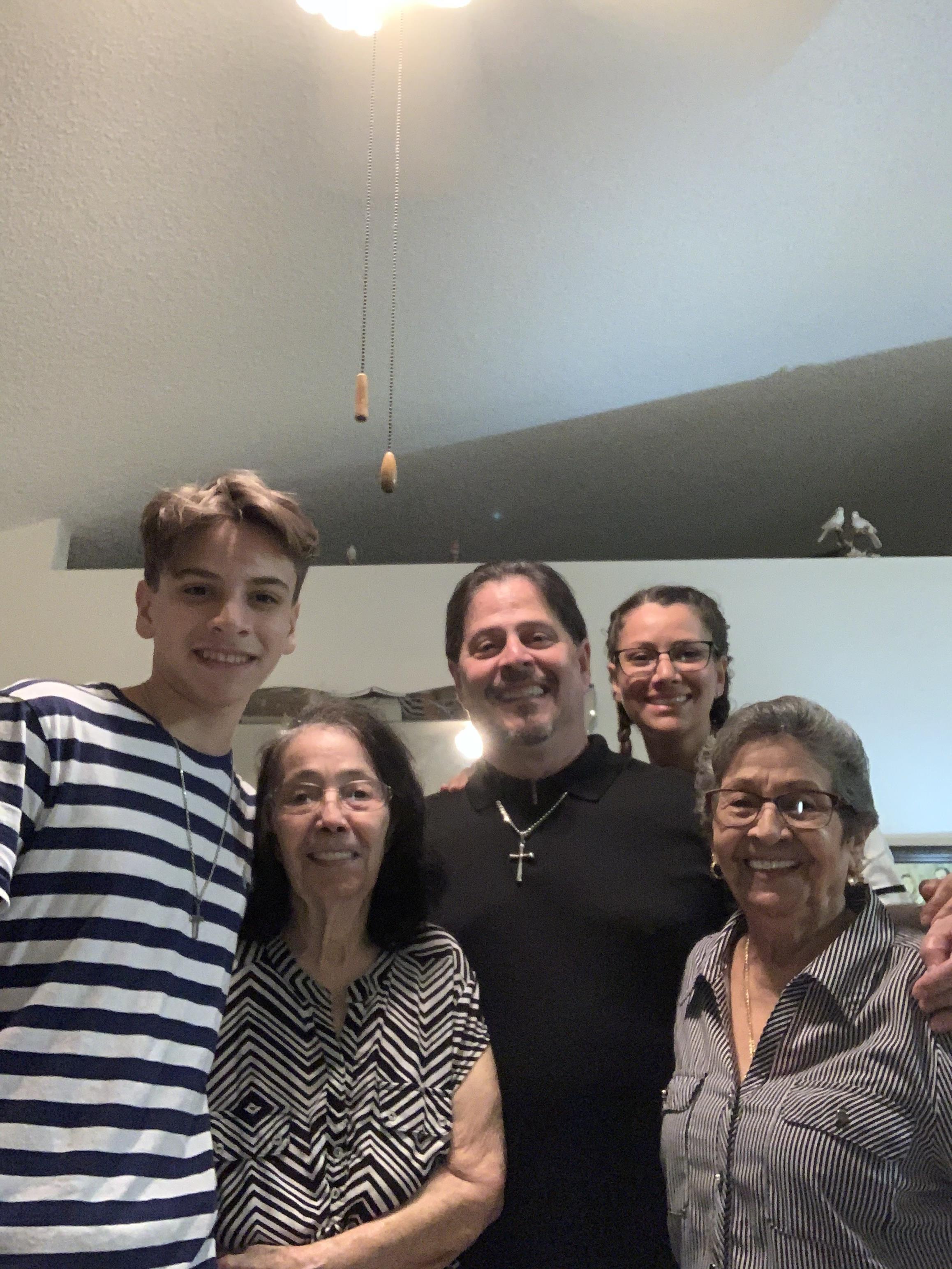 A joyful family poses together in a warm, inviting living room filled with love and laughter.