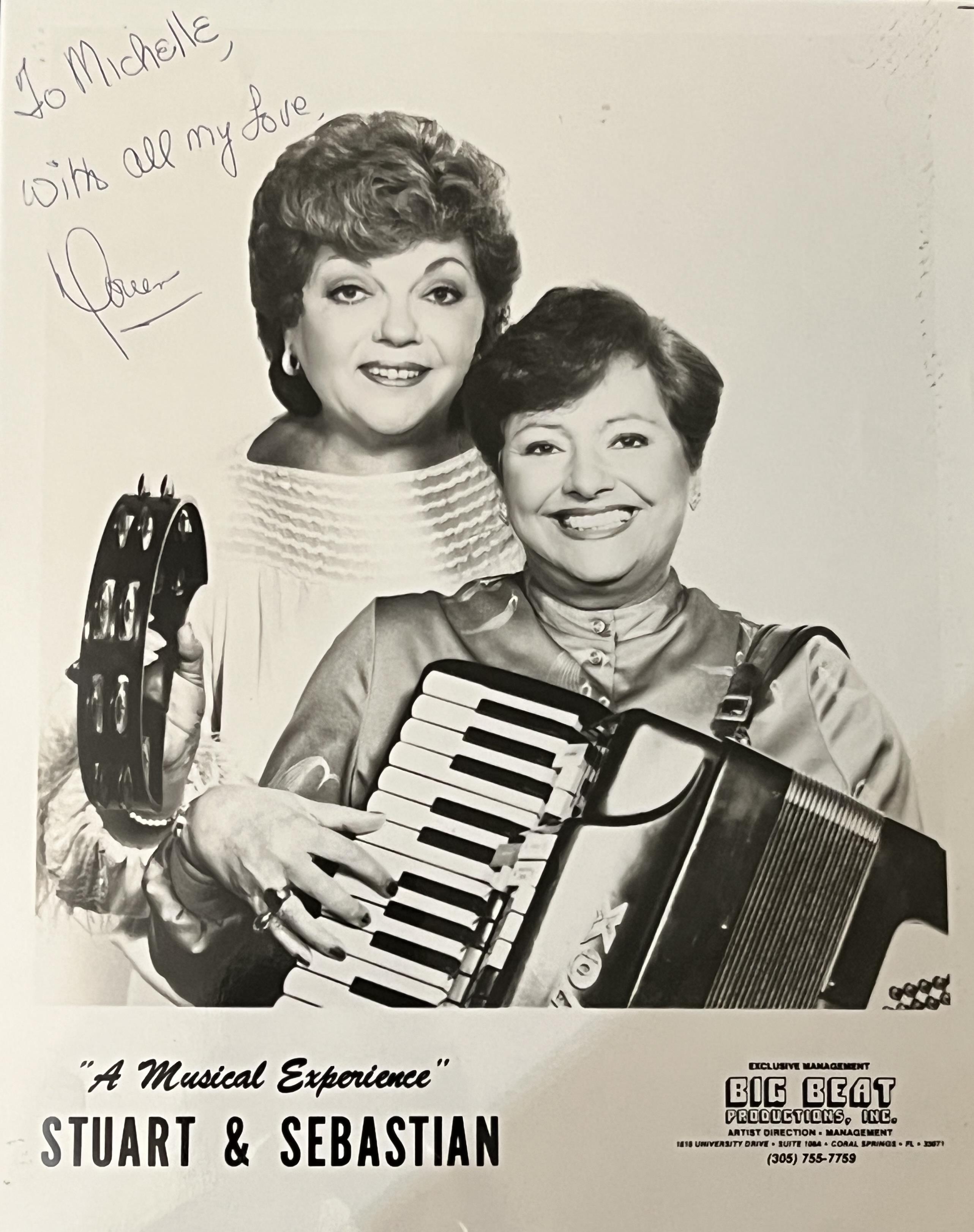 Musicians are smiling and posing with instruments in a professional setting.