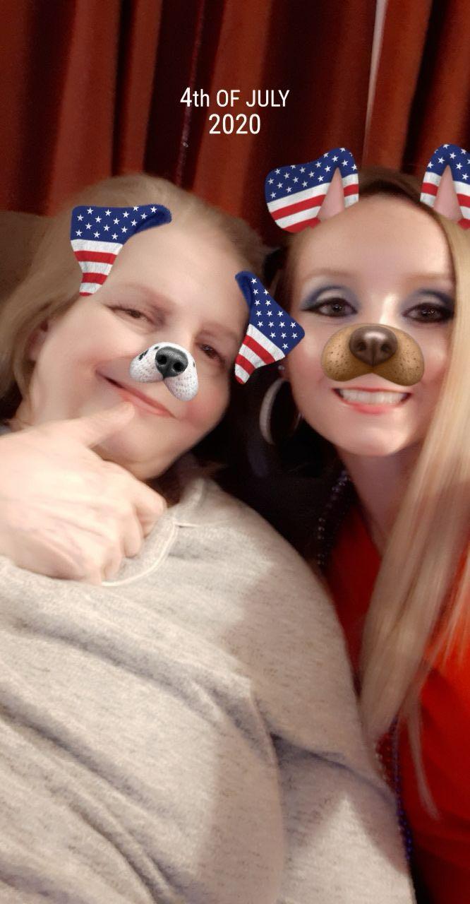 Two friends smile happily while using playful filters, showcasing their joy and camaraderie.