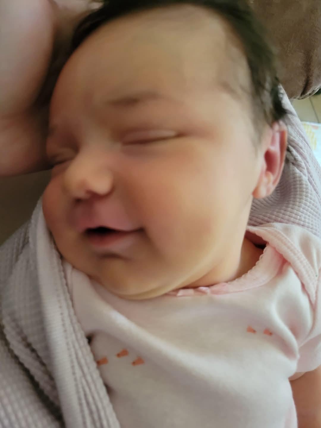 A content baby sleeps soundly, wrapped in a cozy blanket, displaying a serene expression.