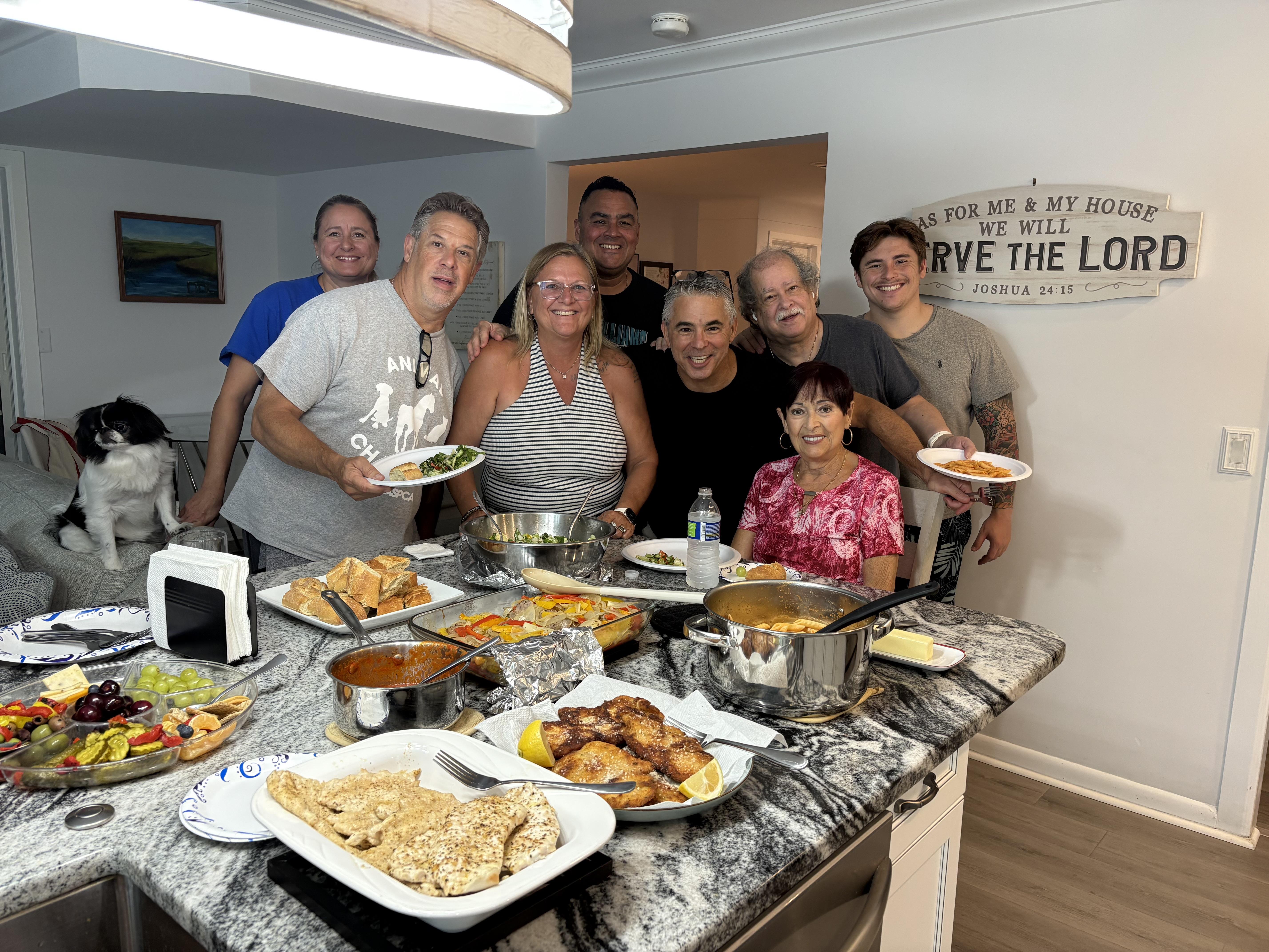 Friends share laughter and delicious food in a cozy kitchen setting, creating lasting memories.