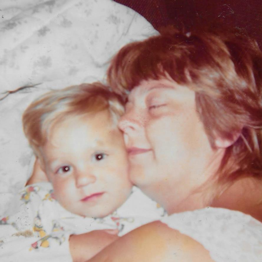 A mother embraces her young child, sharing warmth and affection in a cozy setting at home.