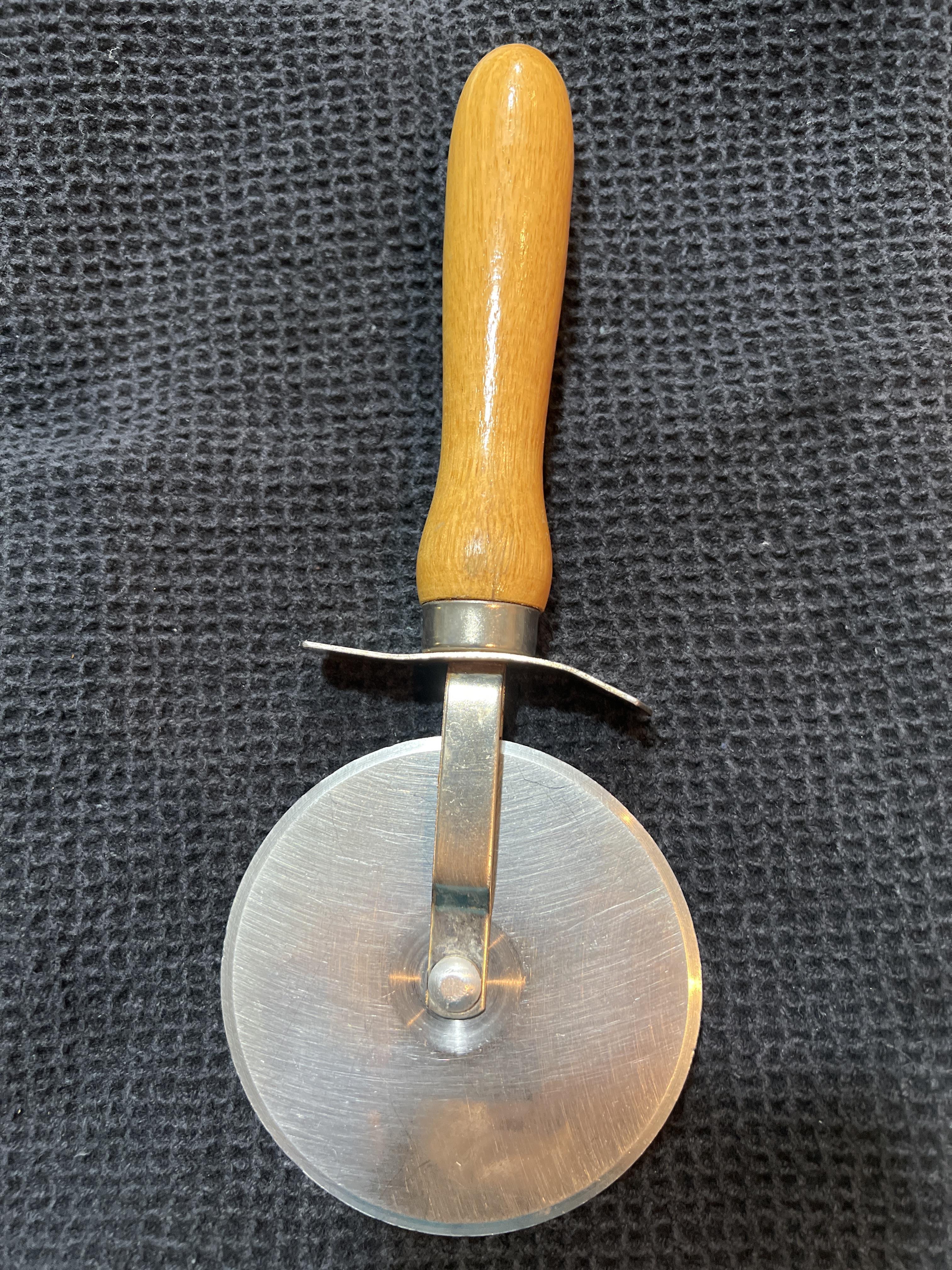 This pizza cutter features a durable metal blade and an ergonomic wooden handle for easy use.