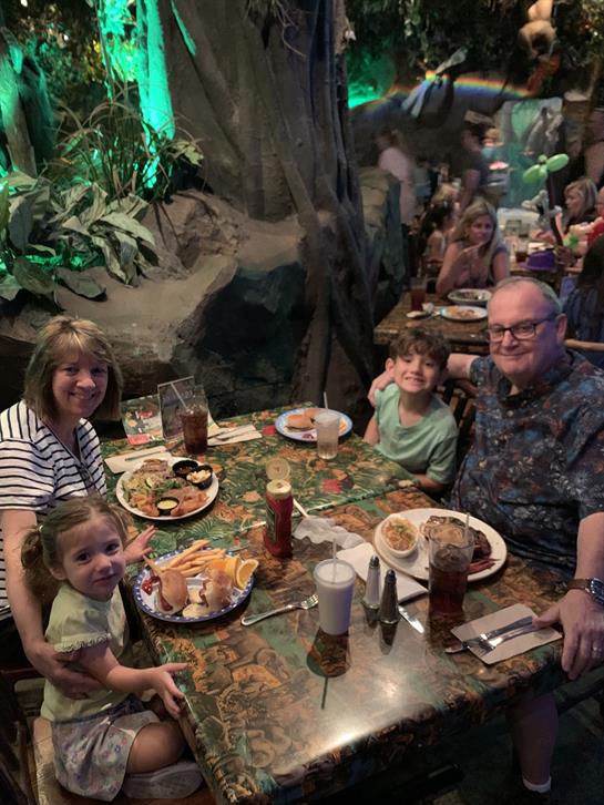 A group of people sitting at a table with food