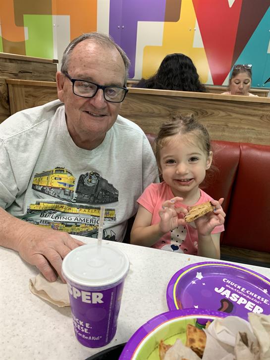 A man and a girl sitting at a table