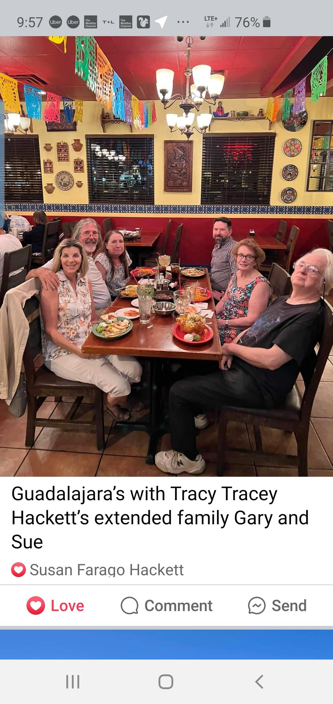 A group of six friends and family members shares a delightful meal together at a restaurant.