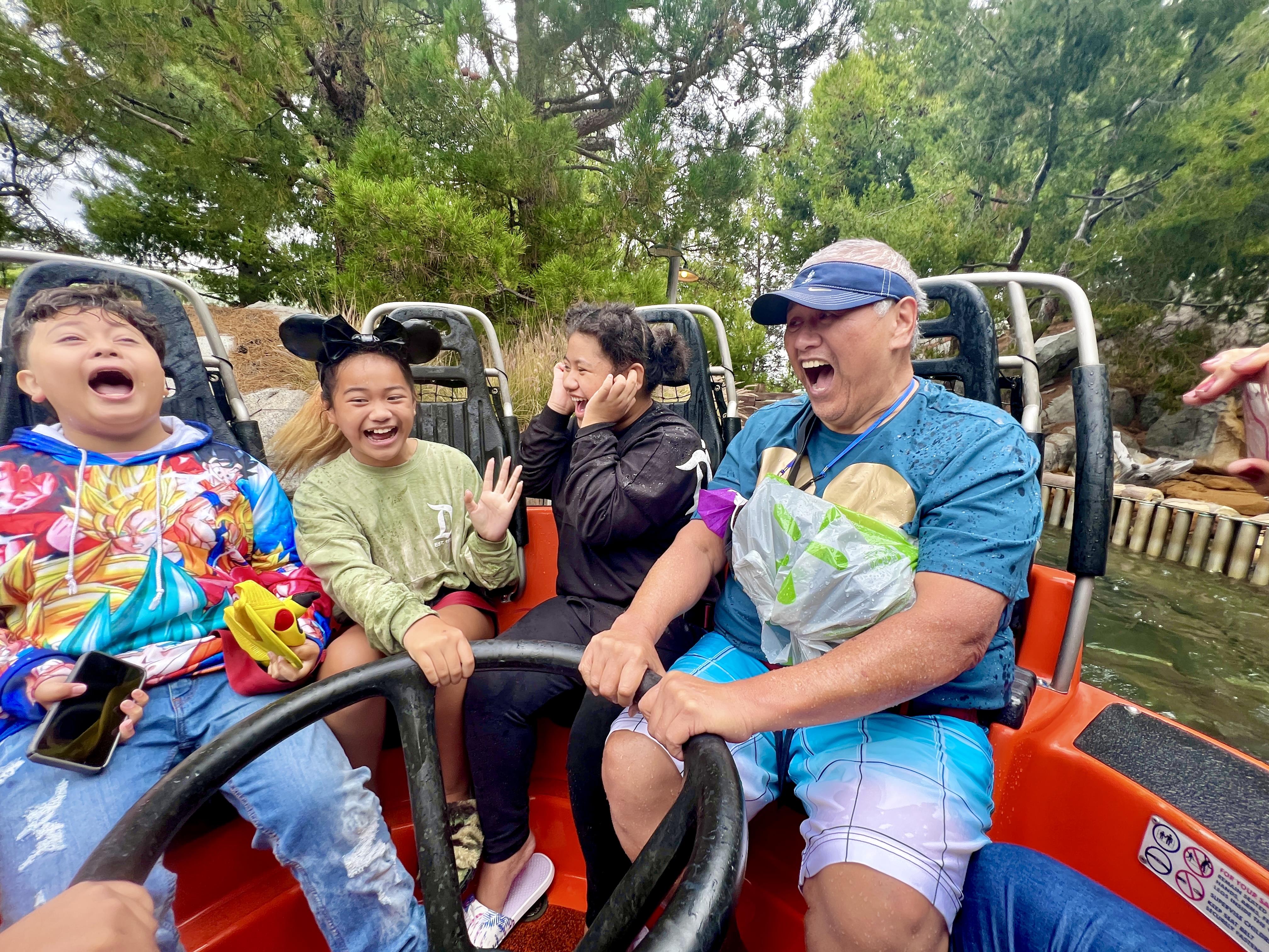 Friends share laughter and excitement as they experience a thrilling amusement park ride together.