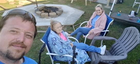 A group of women sitting in chairs outside