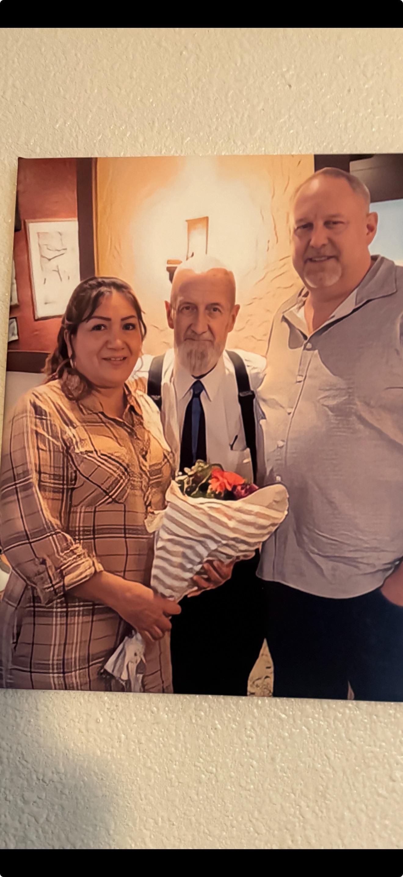 Friends and family gather to celebrate a special occasion, sharing smiles and flowers.