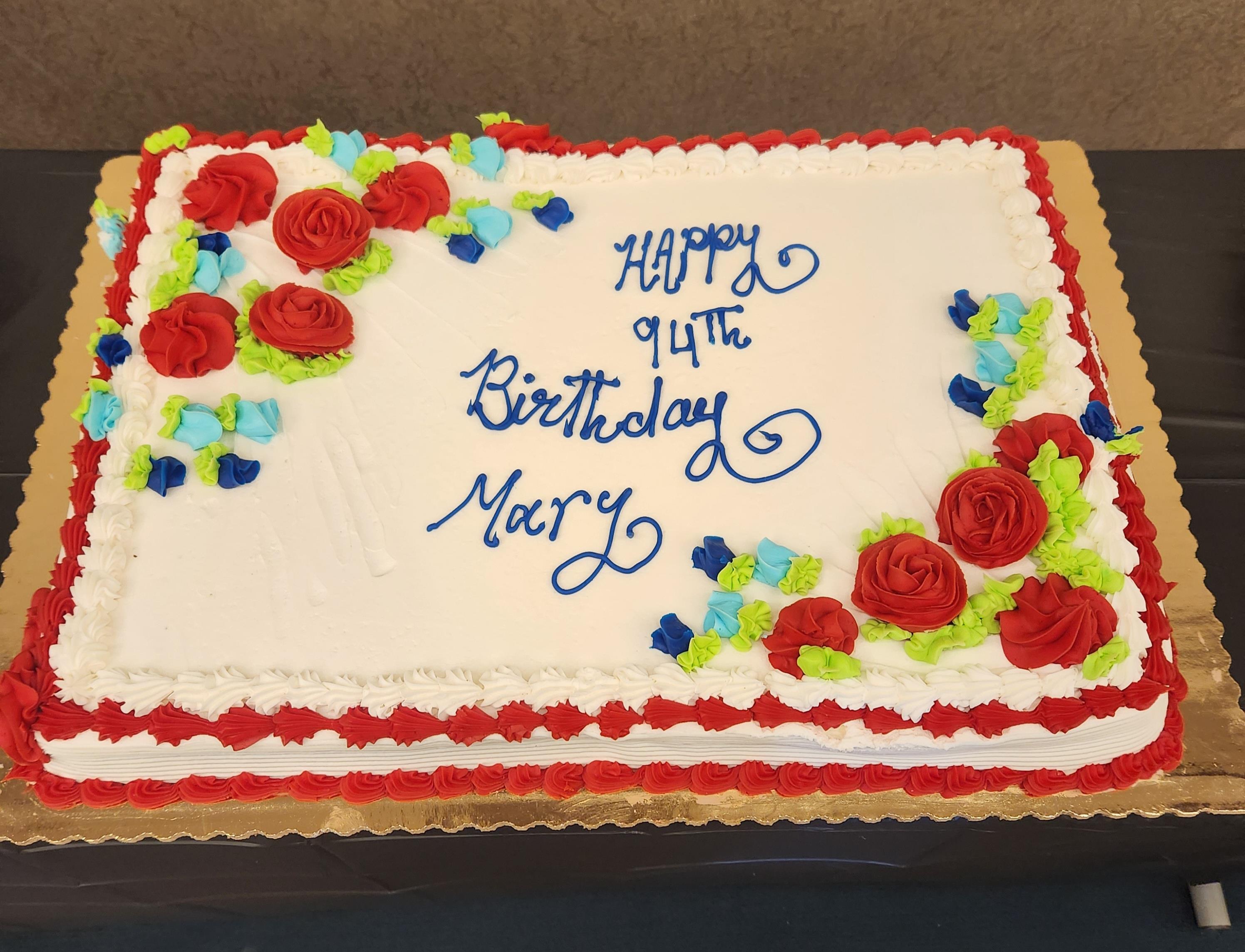 A decorated cake celebrates a milestone birthday with colorful frosting and a heartfelt message.