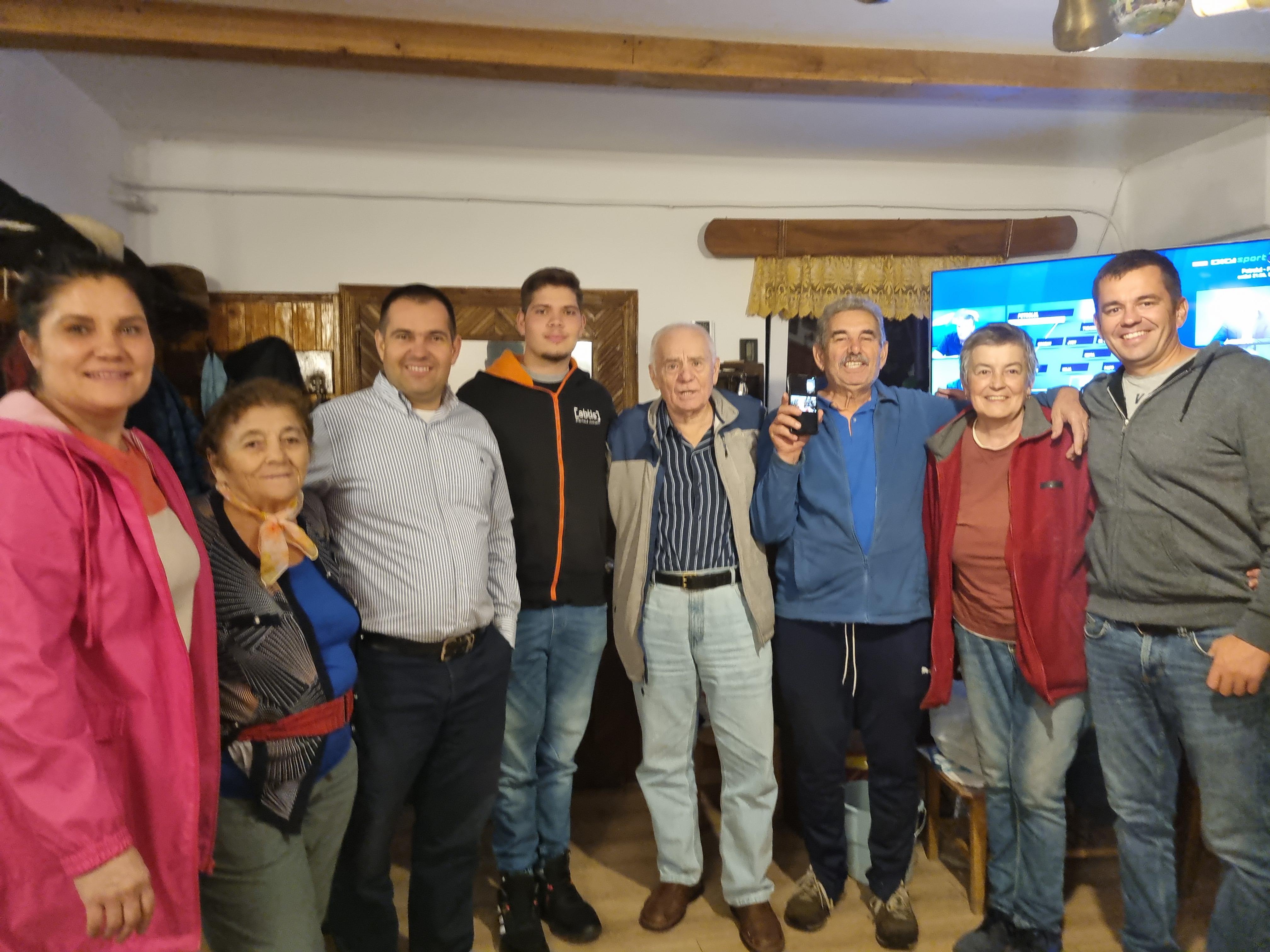 Friends gather for a joyful celebration, sharing laughter and drinks in a warm setting.