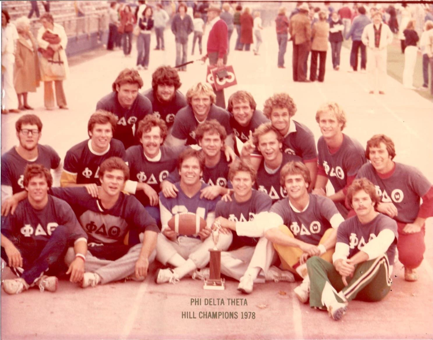 Young men pose together, celebrating their victory as hill champions in 1978 at an outdoor event.