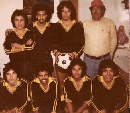 A local soccer team stands together, displaying their uniforms and camaraderie before a match.