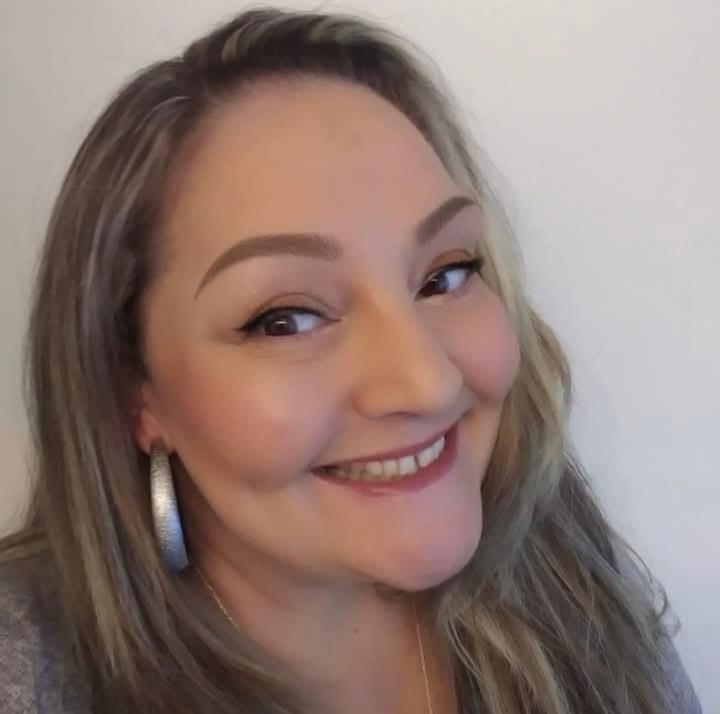 A woman smiling for a selfie