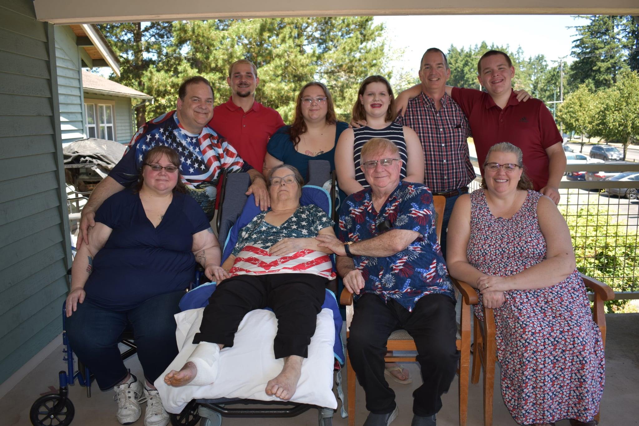 A joyful family reunion with multiple generations enjoying time together in the sun.