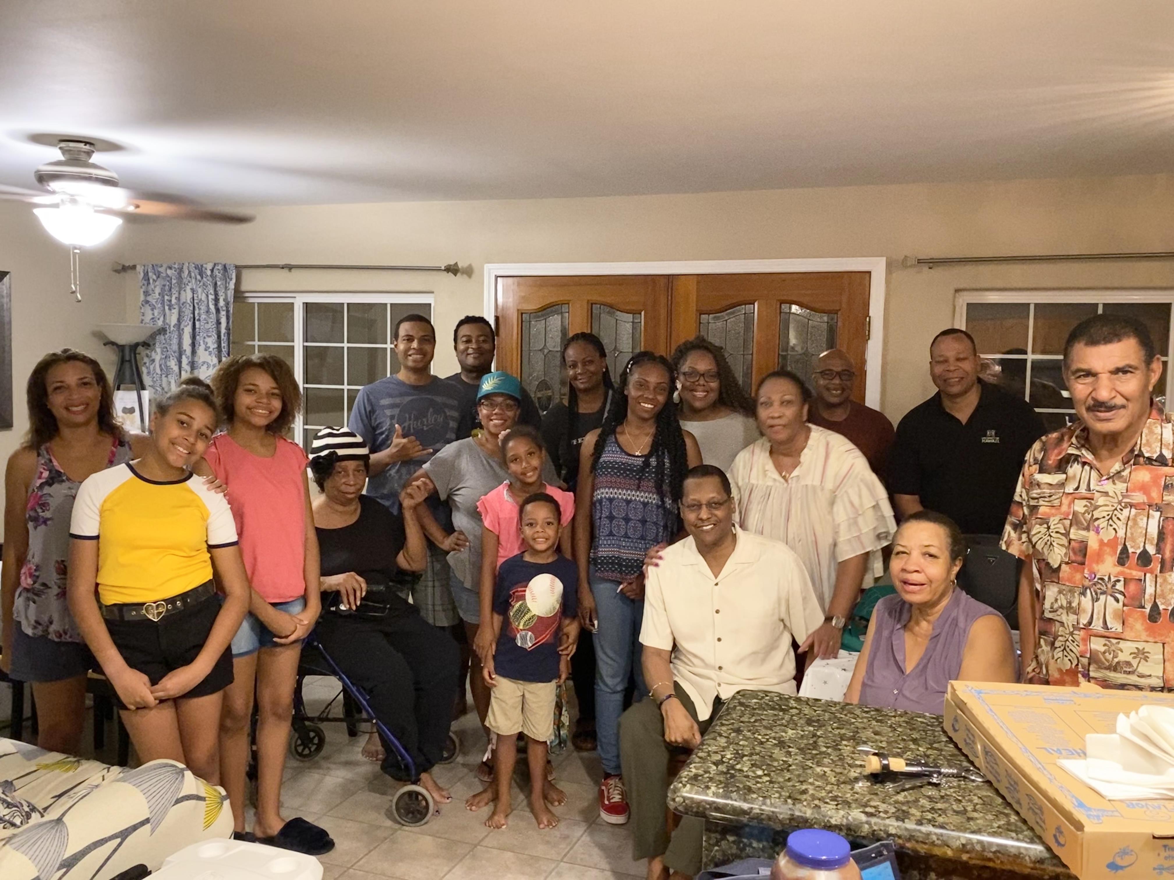 A large group of family members enjoys quality time together in a warm living room atmosphere.