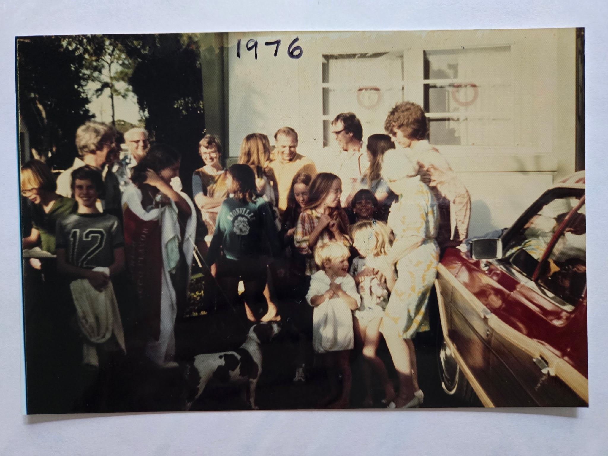 A joyful family reunion featuring multiple generations enjoying time together outdoors.