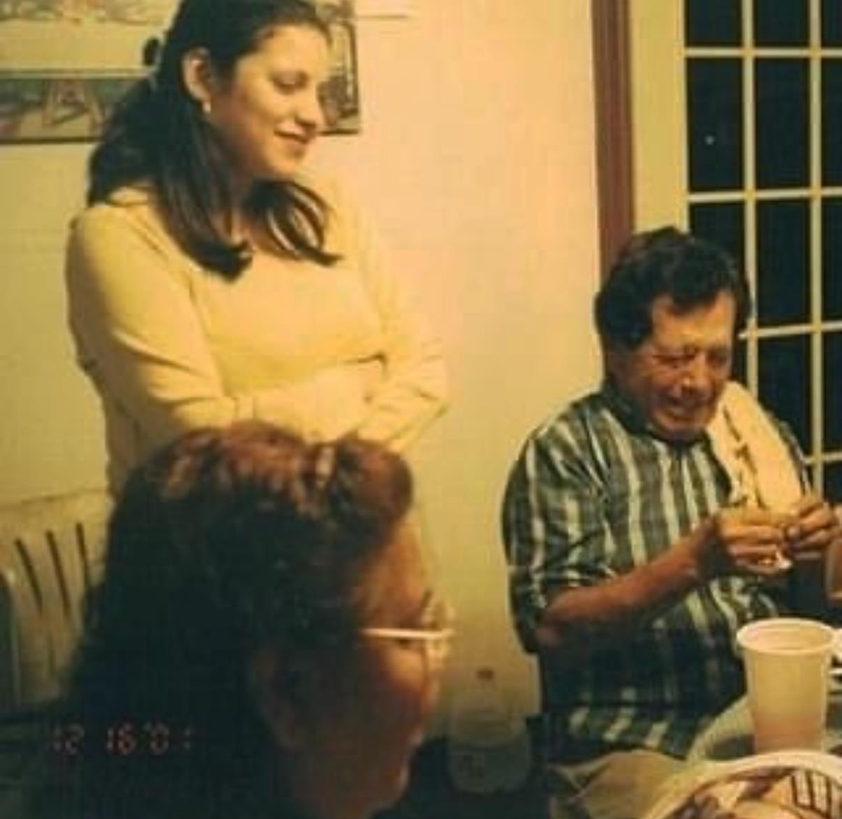 Friends and family share joyful moments around a table, enjoying each other’s company at night.