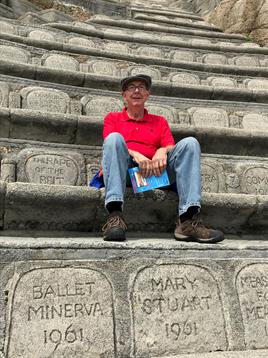 A man sitting on a stone steps