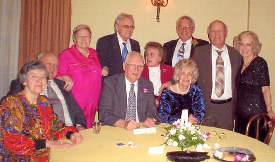 A group of old people posing for a photo